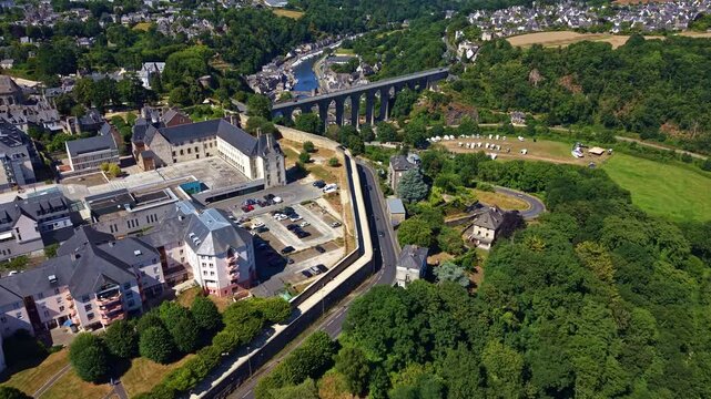 Ch&acirc;teau de Dinan, Porte Saint-Louis, Dinan Viaduct and the Rance River in Dinan, C&ocirc;tes-d'Armor, Brittany, France, revealing the fortified medieval city and surrounding valley, drone forward flyover.
