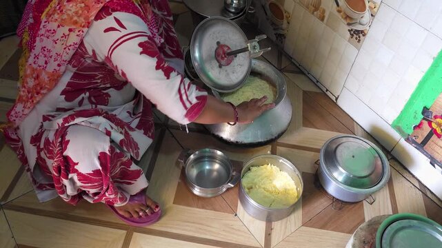 Person preparing homemade traditional meal in a home kitchen a is sitting on a tiled floor 