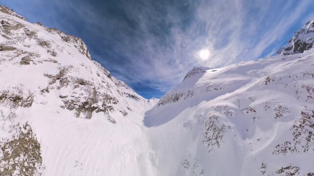 Stunning aerial panorama of the majestic snow covered Alps in Cavloc, Switzerland, on a sunny day