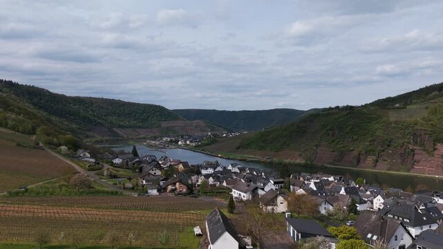 Beautiful aerial footage showcasing Cochem, Germany, with its historic town, flowing river, and lush vineyards.