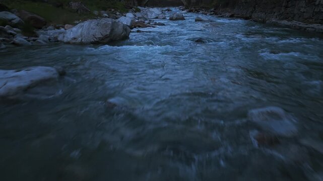 Aerial view of a fast flowing mountain river with rapids in Piuro, Lombardy