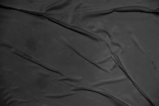 Cardboard black abstract texture close-up. Dark old paper background. Grunge concrete wall. Vintage blank wallpaper.