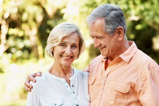 Senior, couple and smile in park with love, bonding and romance in nature for commitment. Portrait, happy and care with man, woman and together in retirement for marriage, connection and outdoor