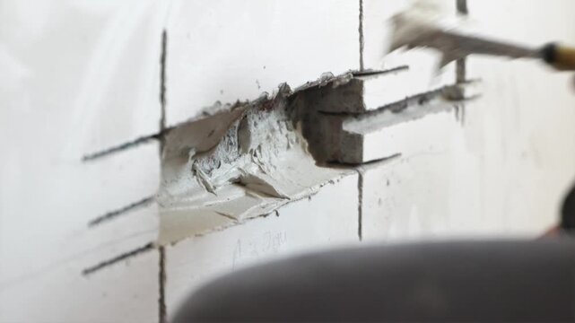 Applying plaster putty inside freshly drilled wall socket hole