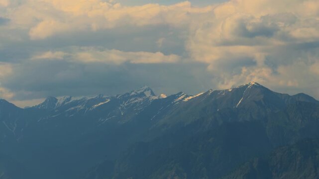 4K Handheld shot of Himalayan mountain range with snowy peaks as seen from Chamba Garh near Lot village in Kullu district, Himachal Pradesh, India. Scenic natural view of Himalayas in sunset.