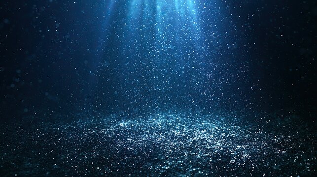 Deep blue underwater scene with sparkling particles illuminated by light beams
