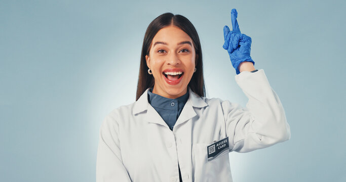 Idea, science and smile with portrait of woman in studio for healthcare solution, eureka or pointing. Medical breakthrough, research and problem solving with person on white background with space