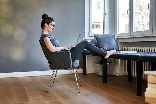 Young woman using laptop at home
