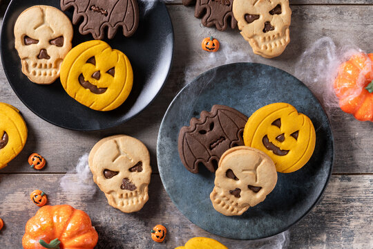 Assorted Halloween cookies on wooden table. Top view