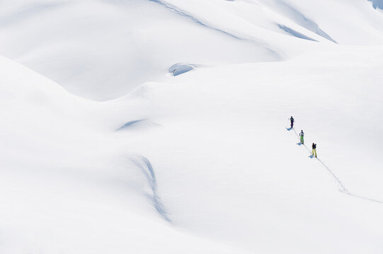 Skiers explore the snowy mountains of Seiseralm in South Tirol
