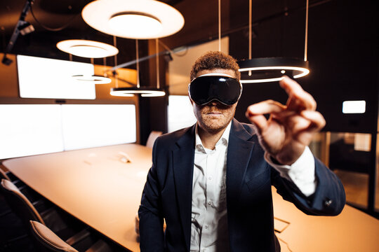 Businessman uses virtual reality headset in modern office