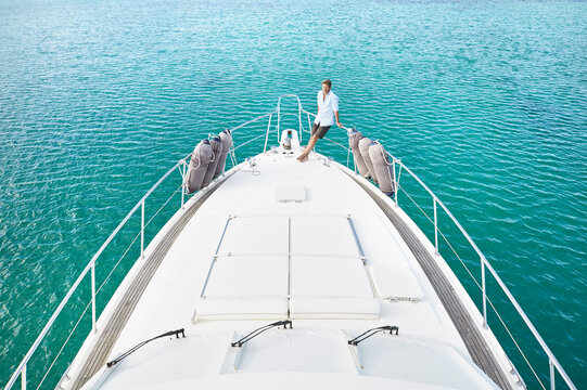 Mature man on deck of his motor yacht