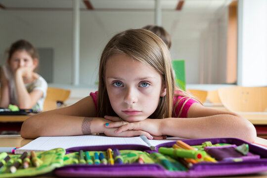 Portrait of bored schoolgirl at class