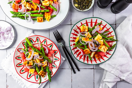 A fresh summer salad features grilled halloumi and green asparagus