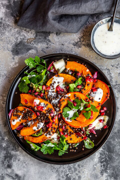 Autumnal salad with fried pumpkin, lentils, radicchio, pomegranate seeds, leaf salad and parsley with dressing