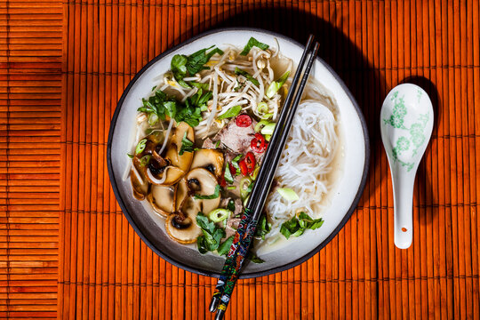 Vietnamese rice noodle soup with mushrooms and beef