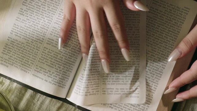young conservative asian Woman Reading the Bible at table with bread food and drink indoors	