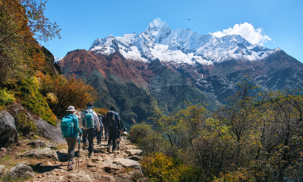 Panoramic view of hikers walking on trail to Everest Base Camp with majestic snow capped mountain peaks in Nepal. EBC trek, Himalaya adventure.