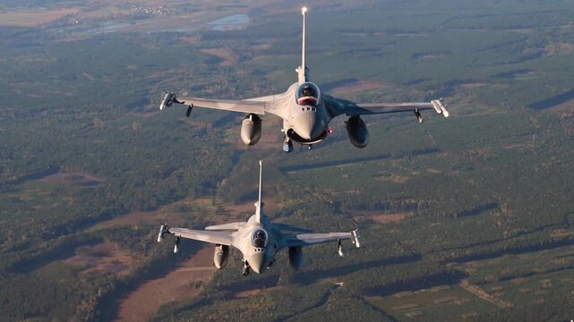 Twin F-16 Fighting Falcons Fly in Perfect Formation Demonstrating Precision, Speed, Tactical Readiness, and Air Superiority Excellence.