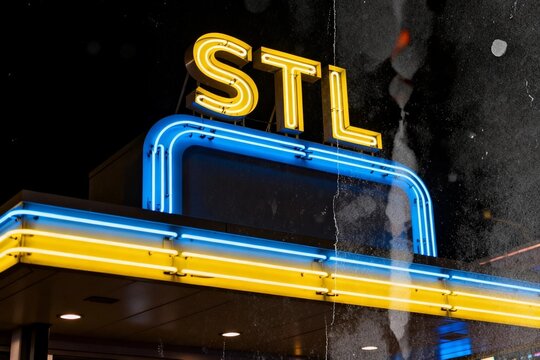 Neon 'STL' Sign at Night with Rainy Reflection