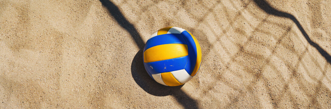 Beach volleyball court with a volleyball ball placed in the sand.