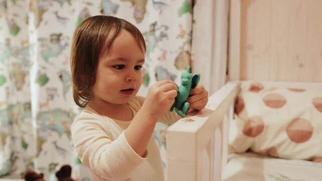 Happy child discovering a colorful dragon toy while playing indoors in a cozy wooden home