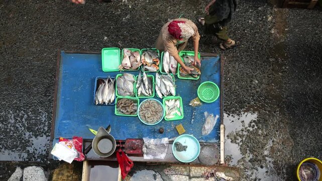 A bustling fish market comes alive during the early morning hours, where vendors and buyers engage in the daily trade of fresh seafood and fish. Operating from around midnight until 7am