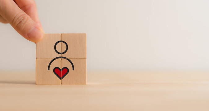 Employee Motivation or Brand Loyalty concept. Wooden blocks with employee blocks with heart symbols, representing motivation, brand loyalty, employee engagement, recognition and commitment.
