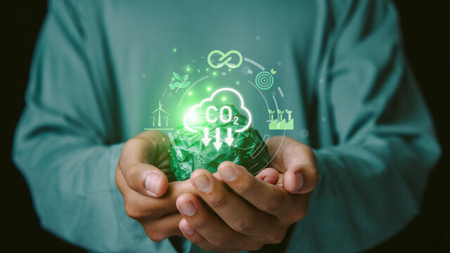 commitment, increase, responsibility, planet,Hands holding a green paper globe with CO₂ reduction interface highlighting net zero goals, renewable energy and sustainable environmental practices.