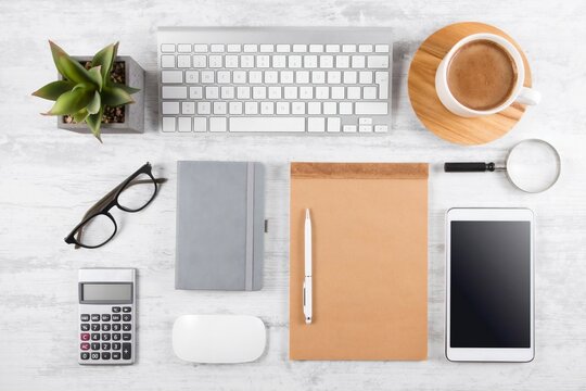 Minimal modern workspace featuring laptop, coffee cup and office accessories on a clean wooden desk. Suitable for business, remote work and productivity concepts.
