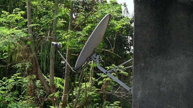 A DTH (Direct-to-Home) connection dish antenna is installed on a roof wall facing south of a house situated in a forest. United States has listed India&rsquo;s preference for the use of domestic satellites 