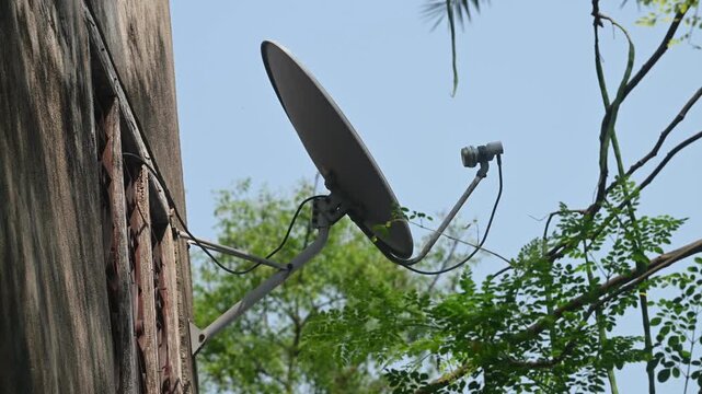 A DTH (Direct-to-Home) connection dish antenna is installed on a roof wall facing south of a house situated in a forest. United States has listed India&rsquo;s preference for the use of domestic satellites 