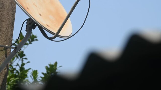 A DTH (Direct-to-Home) connection dish antenna is installed on a roof wall facing south of a house situated in a forest. United States has listed India&rsquo;s preference for the use of domestic satellites 