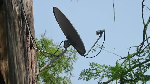 A DTH (Direct-to-Home) connection dish antenna is installed on a roof wall facing south of a house situated in a forest. United States has listed India&rsquo;s preference for the use of domestic satellites 