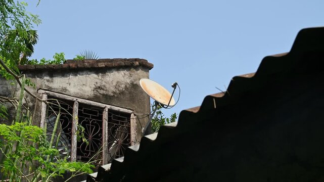 A DTH (Direct-to-Home) connection dish antenna is installed on a roof wall facing south of a house situated in a forest. United States has listed India&rsquo;s preference for the use of domestic satellites 