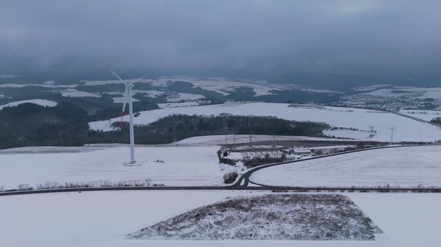Wind turbine and solar panel in snow, dark doldrums or wind lull in winter, no renewable sustainable energy, environmental conversation