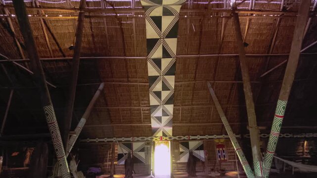 Traditional indigenous communal house at Aldeia Multi&eacute;tnica, Chapada dos Veadeiros, Alto Paraiso de Goias, Goias, Brazil, reveals a monumental thatched roof, painted ceremonial beam