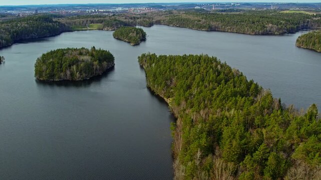 Aerial view of forested islands and calm lake in Stora Delsjon nature reserve, Sweden