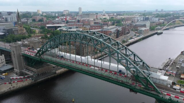 Hyperlapse drone shot iconic arched steel Tyne Bridge with traffic over river in Newcastle