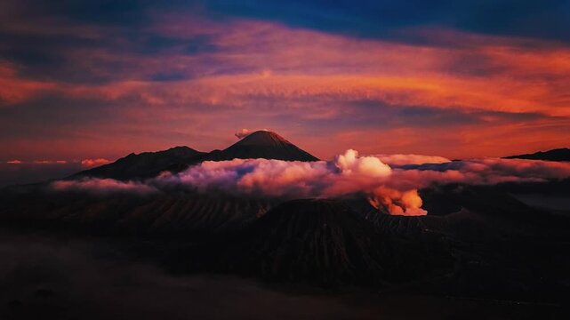 A breathtaking time-lapse capturing the golden sunrise illuminating the rugged peaks and mist-filled Tengger Semeru caldera.