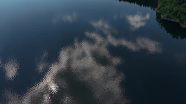 Drone Shot of Clouds Reflections and Coast of Lake Bohinj Slovenia on Sunny Summer Day