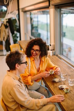 Women of different generations sharing coffee and laughing