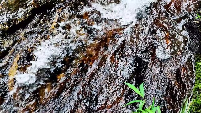 Flowing Water Slow motion  Stream Over Wet Rock Texture, Outdoor Nature Pattern With Stone Surface, Fresh Running Flow And Natural River Current Detail