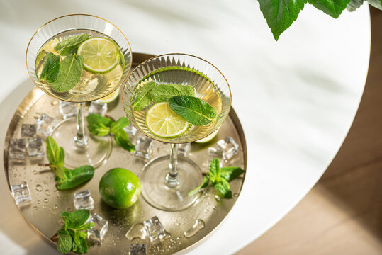 Refreshing mojito cocktails with mint and lime on tray