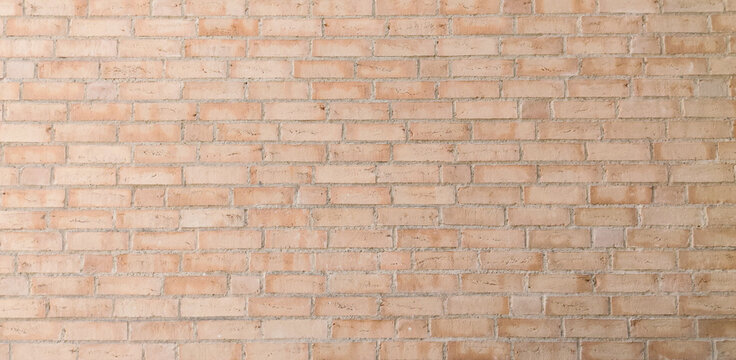 Light orange brown brick wall background with running bond masonry pattern