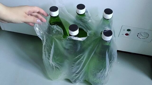 Pack of bottled drinking water on floor, woman taking water bottle, emergency water supply, household water reserve and preparedness concept.