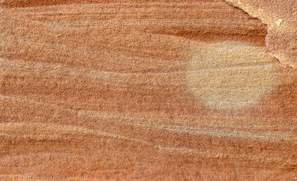 Rough reddish brown sandstone surface texture background with natural horizontal strata