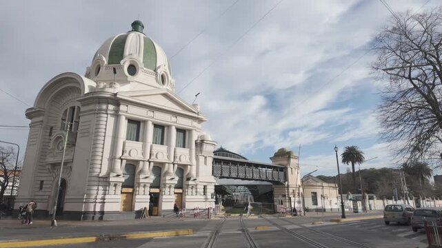 Terminal entrance with vehicle crossing, tracks, and dome at La Plata station, La Plata, Buenos Aires, Argentina. D-Log M, 10-bit color, flat log profile.