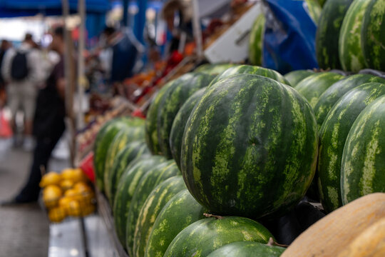 Lots of watermelons in the city market.