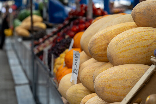 Ripe and juicy melons lie on the counter in the market or bazaar. Sale of ripe and fresh vegetables and fruits at the farmers' market. Close-up.